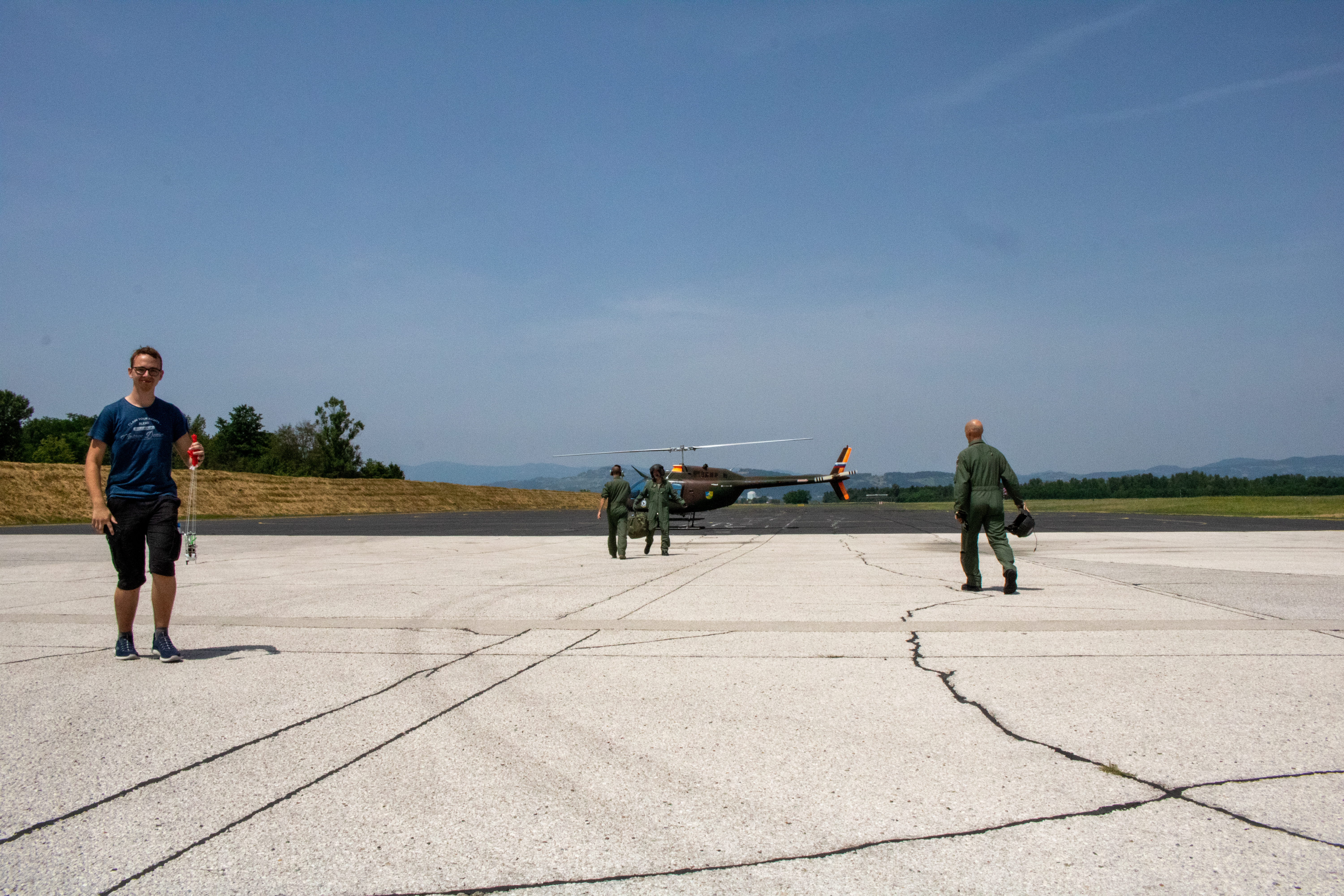 Team member standing with our cansat v1 the last time we saw it
